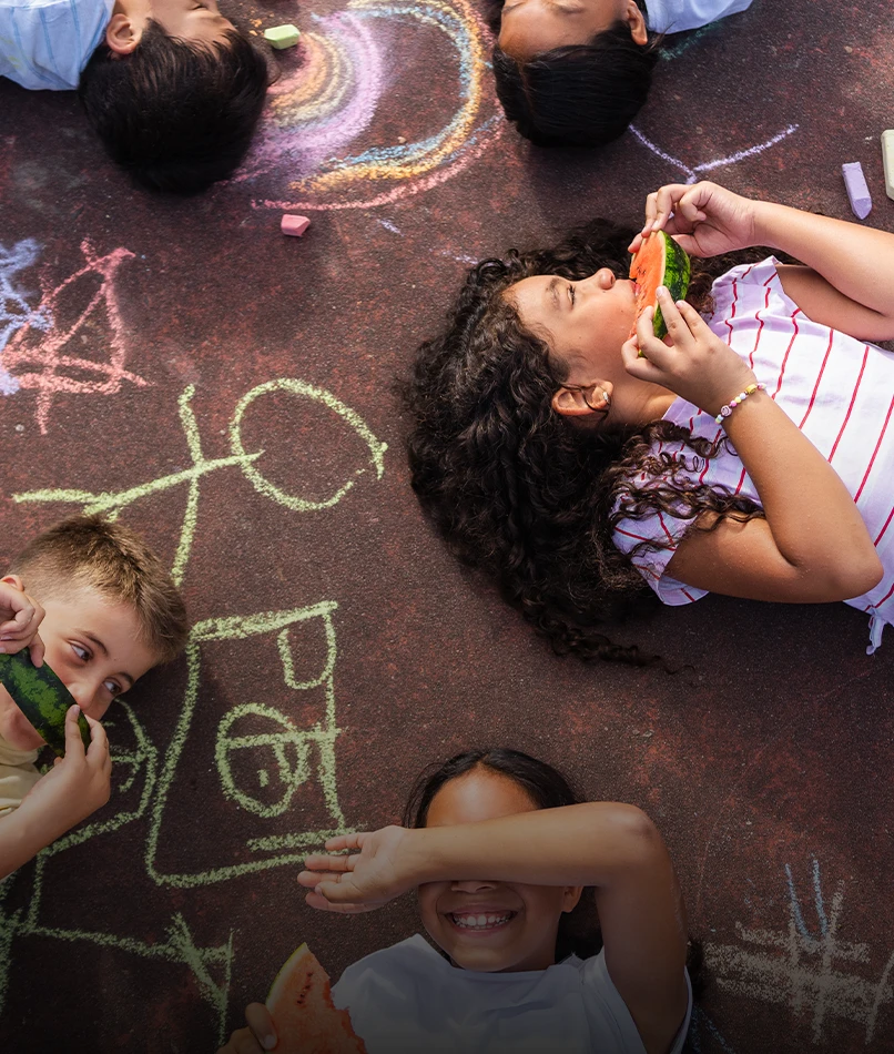Kids lying on the floor, eating water melons (photo)